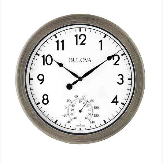 The Bulova Clock - Patio Time (C4879) is a round, weather-resistant outdoor clock with a brushed metal frame, black numbers, hands showing 10:08, and built-in thermometer and hygrometer at the bottom.