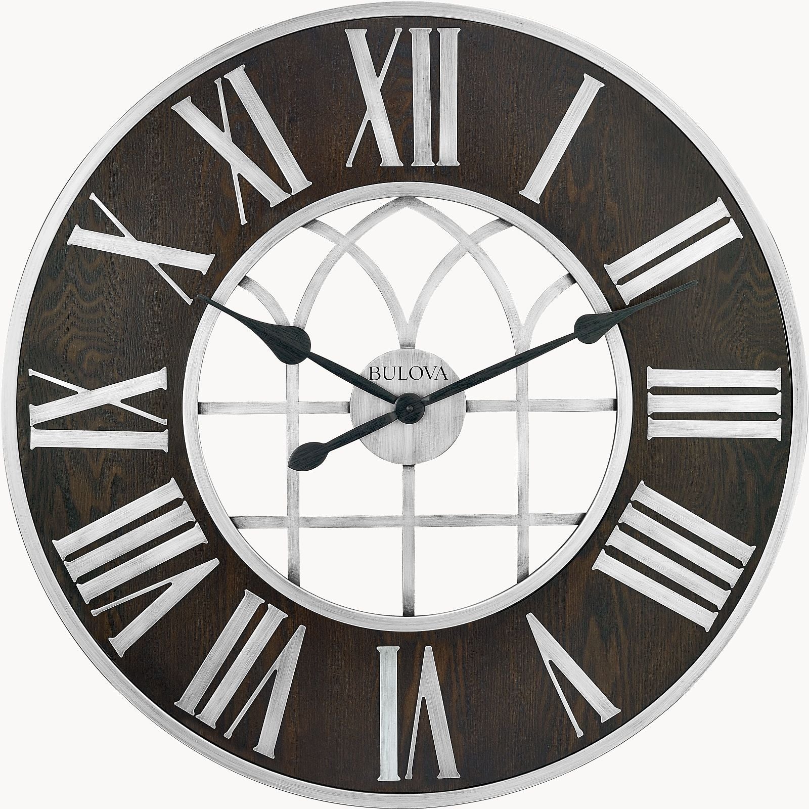 The Bulova Clocks Chapel Street (C4894) is an oversized wall clock with an espresso stain finish, white Roman numerals, silver hands, and a decorative window-patterned center. The time shown is about 10:11. Brand: Bulova.