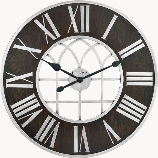 The Bulova Clocks Chapel Street (C4894) is an oversized wall clock with an espresso stain finish, white Roman numerals, silver hands, and a decorative window-patterned center. The time shown is about 10:11. Brand: Bulova.