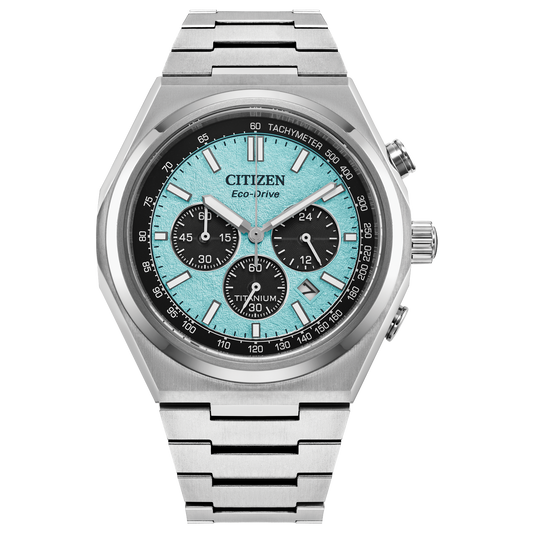The Citizen Zenshin Chrono Super Titanium (CA4610-85M) by Citizen features a silver titanium band and case, blue textured dial with three subdials, black bezel, and silver hour markers.