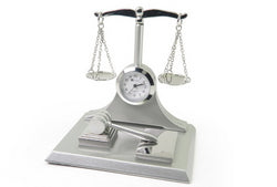 The Sanis Enterprises Mini Clock - Scales of Justice (CK371) is a silver decorative piece featuring a mini clock set in Scales of Justice, with a gavel on the base—an elegant symbol of law and justice.