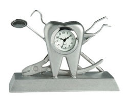 The Sanis Enterprises Sanis Mini Clock - Dental Tray - CK492 features a mini clock set in a metal tooth sculpture, with dental tools arranged behind it on a sleek, dental tray-inspired rectangular base.