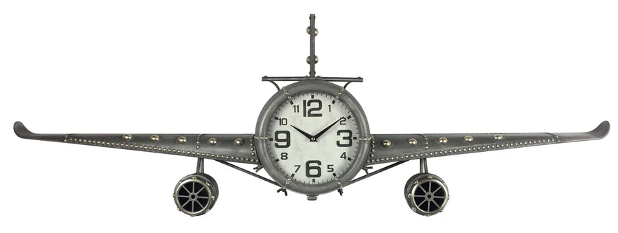 The Peterson - Jet Fighter Wall Clock (CL7106B) by Peterson is a handcrafted iron clock, featuring a jet nose and cockpit face, metal wings, and jet engines—an ideal industrial accent for any room.