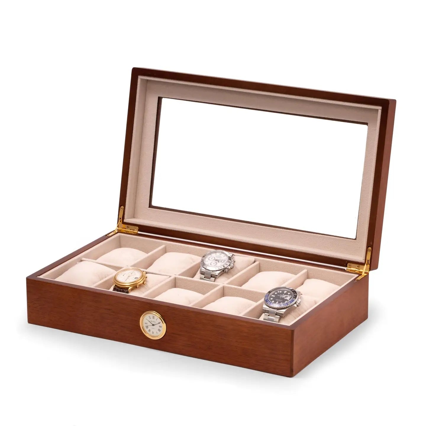 The Bey-berk CM639BRW is a brown cherry wood watch box with a glass lid, beige interior, and 10 compartments. Three slots hold gold, silver, and black wristwatches. A small quartz clock is embedded in the front of the box.