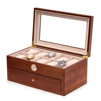 The Bey-berk BeyBerk Watch Box - Brown 20 Watch Box with Clock (CM640BRW) has a glass lid, holds up to 20 watches with several empty compartments, a small bottom drawer, and a round clock embedded on the front.
