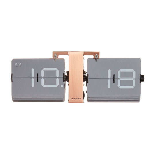 The Cloudnola Flipping Out Gray - 0031 is a modern flip clock with a copper stand, showing 10:18 AM on two gray panels with white numbers. The Cloudnola logo appears on the central stand, merging retro style with modern design.