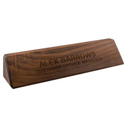 A JDS Walnut Desk Wedge 10.5" (DS10) nameplate by JDS, engraved with "ALEX BARROWS CUSTOMER SERVICE MANAGER," is shown on a white background.