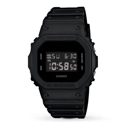 The VLC Distribution Co. G-Shock Watch - Square - DW5600BB-1 is a black digital watch with a durable design and black resin band, displaying 10:58:50, Sunday, and 6-30 on its screen.
