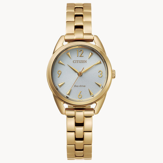 The Citizen EcoDrive Weekender (EM0682-74A) women’s watch by Citizen features a gold-tone case, white dial, gold markers, and a linked metal band—stylish and sustainable, displayed upright against a plain white background.