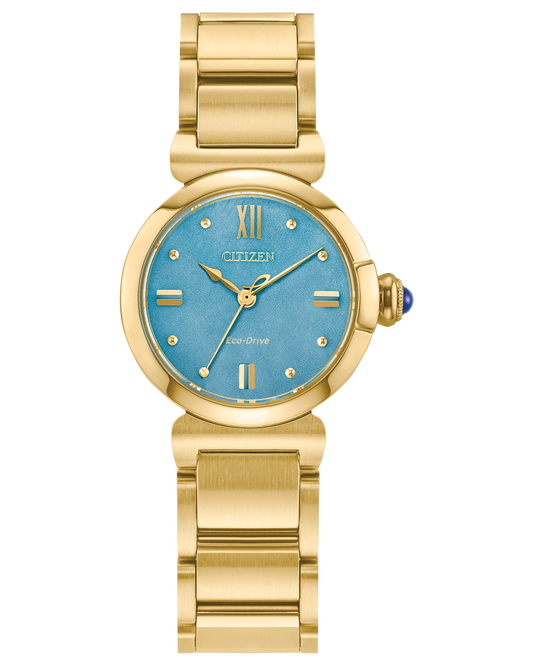 The Citizen L Mae (EM1133-85L) by Citizen is a gold Eco-Drive ladies’ watch with a turquoise blue face, gold hour markers, Roman numerals at 12 and 6, a gold metal band, and a small blue cabochon on the crown.