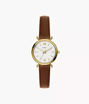 The Fossil Carlie Mini ES5464 is a women’s gold-tone stainless steel watch with a round case, white dial, gold markers, and a brown leather strap.
