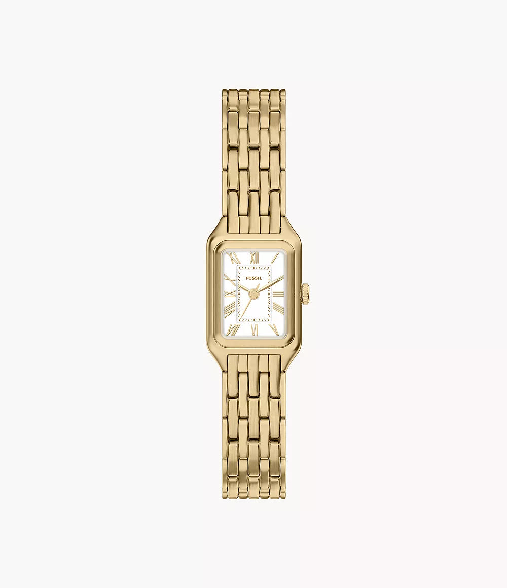 The Fossil Raquel ES5467 is a women’s rectangular watch with a gold-tone stainless steel band, white face with Roman numerals, quartz three-hand movement, and the Fossil brand name on the dial.