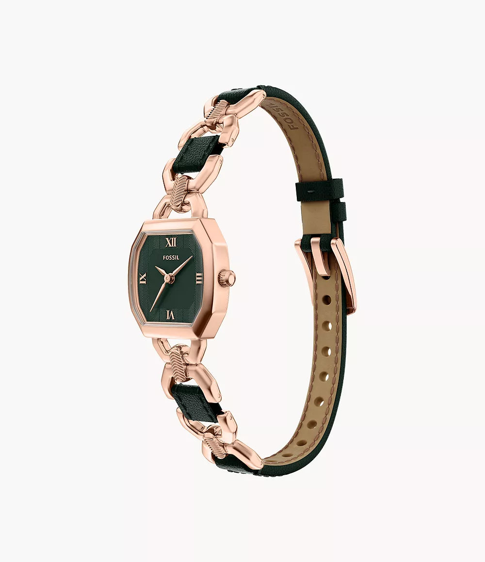 A Fossil Harlow ES5498 wristwatch featuring a rose gold-tone case, black rectangular dial with Roman numerals, and a black leather strap adorned with rose gold chain links and a buckle clasp.