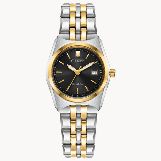 The Citizen Watch - Corso - EW2299-50E is a women’s Eco-Drive watch with a black dial, gold hour markers, date window at 3 o’clock, and a two-tone stainless steel bracelet.