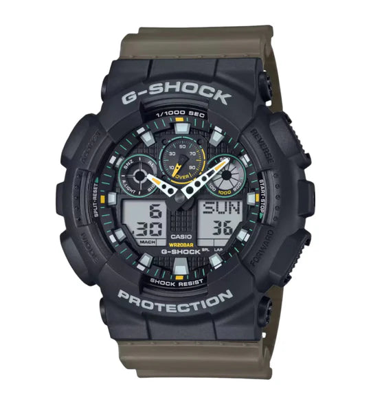The Casio G-Shock Watch - GA-100TU-1A3 by VLC Distribution Co. features a rugged black, shock-resistant design with "Protection" and "G-Shock" on the bezel, multi-dial display, and green/yellow accent hands for time and date.