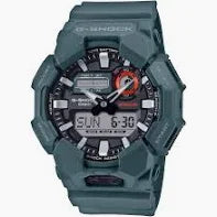 The G-Shock Watch - GA010-2ACR by VLC Distribution Co. is a rugged green watch with bio-based resin, digital-analog day/date/time display, prominent buttons, and a durable, sporty design.