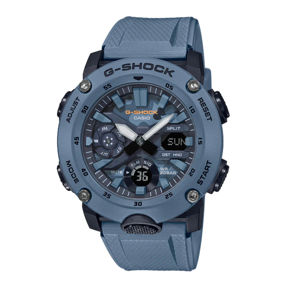 The Casio G-Shock Watch - Carbon Core GA2000SU-2A by VLC Distribution Co. is a blue watch with both analog and digital displays, rugged band, multiple buttons, shock resistance, Carbon Core protection, and shows time and date.