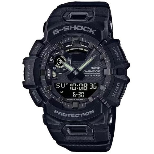 The G-Shock Watch - Smartphone Connectivity - GBA900-1A by VLC Distribution Co. is a black watch with a round face, multiple dials, rugged design, time/date display, digital features, and smartphone connectivity.