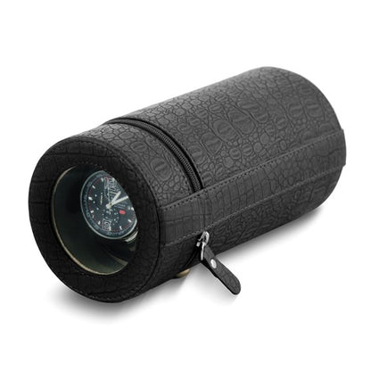 The Quality Gold Watch Winder - Black Faux Crocodile (GM8463) by Quality Gold is a cylindrical, zippered case with a round transparent window, showcasing your watch inside. Ideal as a protective accessory for your timepiece.