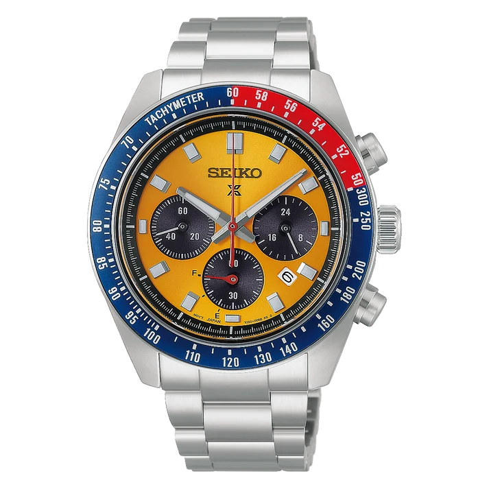The Seiko Watch - Prospex Speedtimer Pogue Solar - HBJ004 is a stainless steel chronograph featuring a striking yellow dial, blue and red bezel, three black subdials, and silver hour markers. Powered by the reliable V192 movement, it includes a tachymeter scale and push buttons on the right side. This Seiko timepiece blends iconic Pogue-inspired design elements with cutting-edge solar technology.