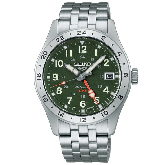 The Seiko Watch - Seiko 5 - HDB001 by Seiko is a field GMT wristwatch featuring a green dial, silver bezel, and metal bracelet. This automatic watch displays the date, has white hour markers, and features a bold red GMT hand.