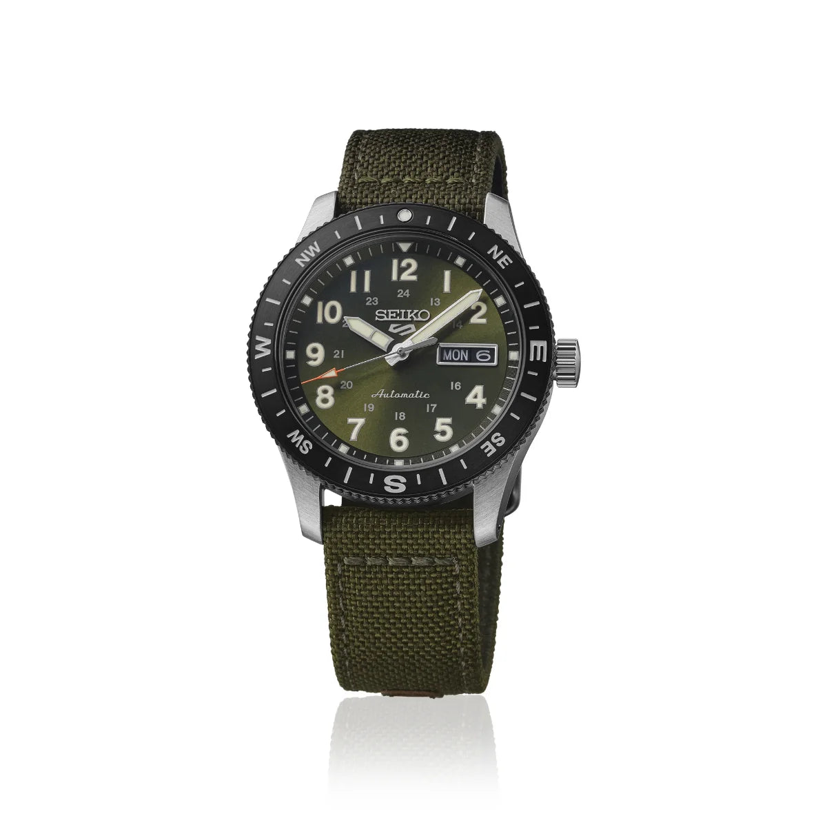 The Seiko Watch - Seiko 5 Field Series - HDB008 by Seiko features an olive green fabric strap, a black rotating bezel, and a green dial that displays the time, day, and date. Set against a white background, this automatic field watch combines durability with style for everyday wear.