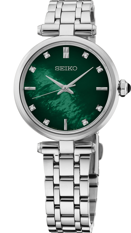 Introducing the Seiko Watch - Ladies' Diamond Collection - HGH006, a sophisticated timepiece from Seiko featuring a breathtaking green mother-of-pearl dial adorned with sparkling diamond hour markers. This elegant silver watch boasts a round face with three sleek silver hands and is complemented by a polished stainless steel bracelet for a timeless, refined look.