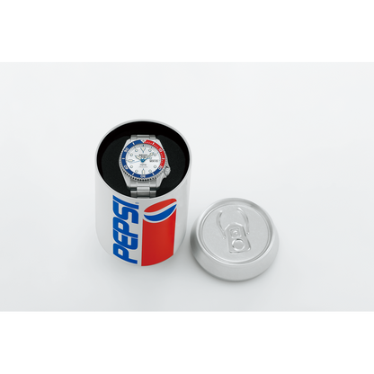 The Seiko 5 x Pepsi® Limited Edition SRPL99 automatic watch with a red, white, and blue bezel is displayed inside a round Pepsi can-style box, its lid off and set beside it.