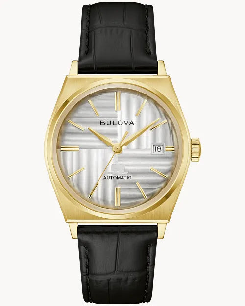The Bulova Watch - Sinatra - 97B243 features a gold-tone stainless steel case, silver dial with gold markers and hands, date at 3 o’clock, black leather strap, and “AUTOMATIC” on the face—an elegant men’s vintage-style watch.