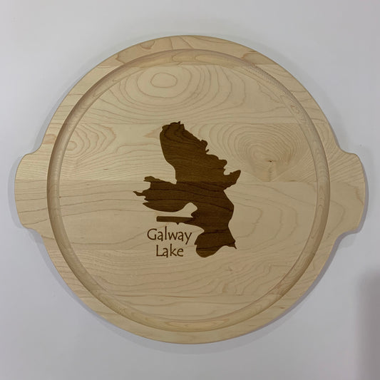 The TS Cutting Board by Time Square Clock Shop is a round custom lake cutting board featuring a laser-engraved Galway Lake design with side handles and "Galway Lake" text, perfect for any home.