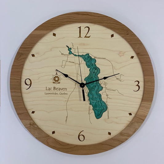 The Lac Beaven - Laurentides Quebec - Lake Wall Clock by Lake Art is a round clock with a wooden face, blue lake map, surrounding land details, and a wood rim featuring numbers at 12, 3, 6, and 9.