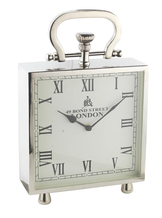 The A Sanoma - Large Nickel Clock (KG227) by A Sanoma is a square silver handmade clock with Roman numerals, 49 Bond Street London on the face, a top handle, small base feet, and shows the time as 10:09.
