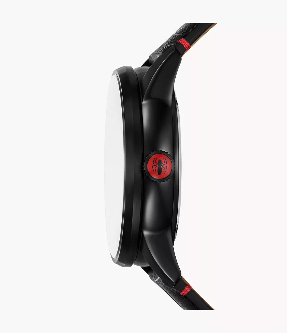 Side view of the Fossil Watch - Marvel Spider-Man - LE1247SET by Fossil in black, displaying the Spider-Man logo on the crown. This watch showcases black lugs and a black leather strap with red stitching accents, all powered by precise Japanese automatic movement. The background is plain white.