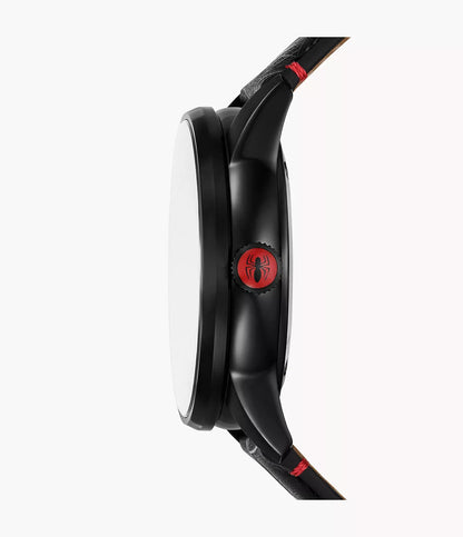 Side view of the Fossil Watch - Marvel Spider-Man - LE1247SET by Fossil in black, displaying the Spider-Man logo on the crown. This watch showcases black lugs and a black leather strap with red stitching accents, all powered by precise Japanese automatic movement. The background is plain white.