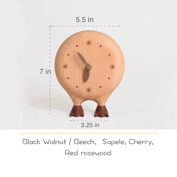 The Senser Woodcraft - Big Foot Clock - LL56 by Senser Woodcraft is a round wooden clock with small feet, standing 7" tall, 5.5" wide, and 3.25" deep, handcrafted from Black Walnut, Beech, Sapele, Cherry, and Red Rosewood for unique home decor.