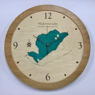 The Lake Art Lake Clock - Madonna Lake is a custom wooden New York lake clock featuring a carved map with blue contours and black hour markers on a light wood face—perfect as unique wall décor for lake lovers.