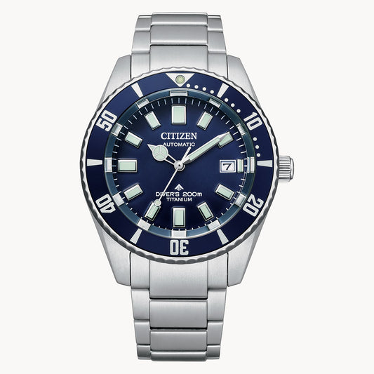 The Citizen Promaster Dive Automatic NB6021-68L features a silver stainless steel bracelet, blue dial, white hour markers, and a date window at 3 o'clock. The dial reads “Automatic,” “Divers 200m,” and “Super Titanium.”.