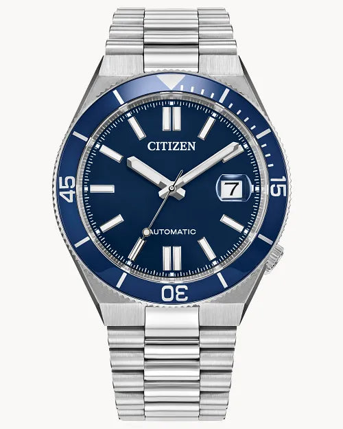 The Citizen TSUYOSA Shore NJ0230-59L wristwatch features a blue dial with silver hands and hour markers, a date window at 3 o’clock, a blue bezel with white minute markings, and a stainless steel bracelet with polished links.