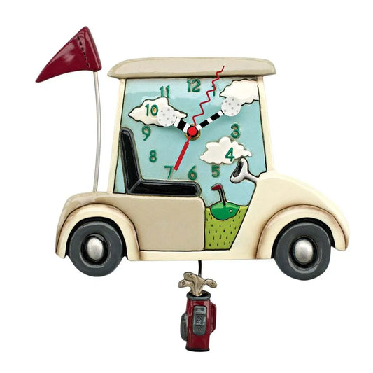 The Enesco Allen Designs Clock - Stay the Course - Golf Cart (P1708) features golf ball hands, green grass, clouds, a red flag, and a dangling golf bag pendulum—perfect whimsical decor for any golf lover. Crisp white background.