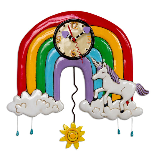 The Enesco Allen Designs Clock - Rainbows & Unicorns (P1806) features a unicorn on clouds, rainbow arch, yellow sun pendulum, and blue raindrop accents—an ideal whimsical wall clock for unicorn lovers.