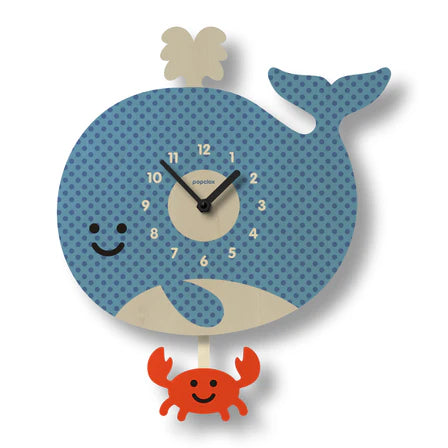 The Popclox Clock - Whale Pendulum Clock (PCPEN037) by Popclox features a blue polka-dotted smiling whale with a red crab pendulum, making it perfect for playful kids’ room decor.
