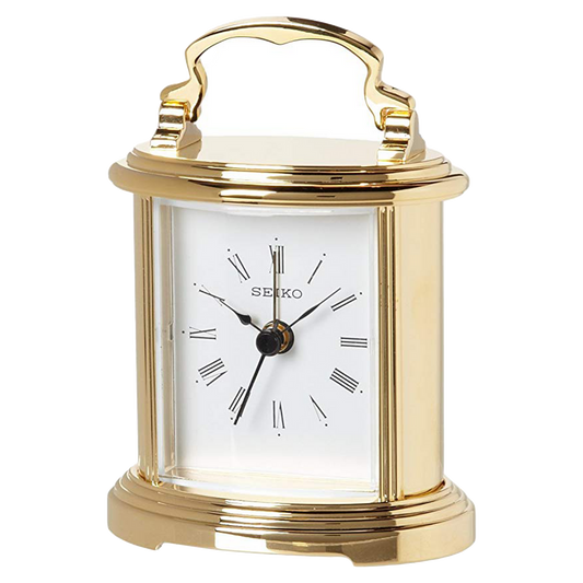 The Seiko Clock - Gold Tone Bedside Alarm (QHE109GLH) features a white face with black Roman numerals and hands, a curved top handle, and a classic design—adding timeless style to any room.