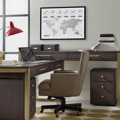 A modern office features a dark wood desk, brown swivel chair, red desk lamp, and neatly arranged books and boxes. On the wall is a Seiko World View Wall Clock (QXA538KLH) by Seiko showing multiple time zones. Storage drawers are nearby.