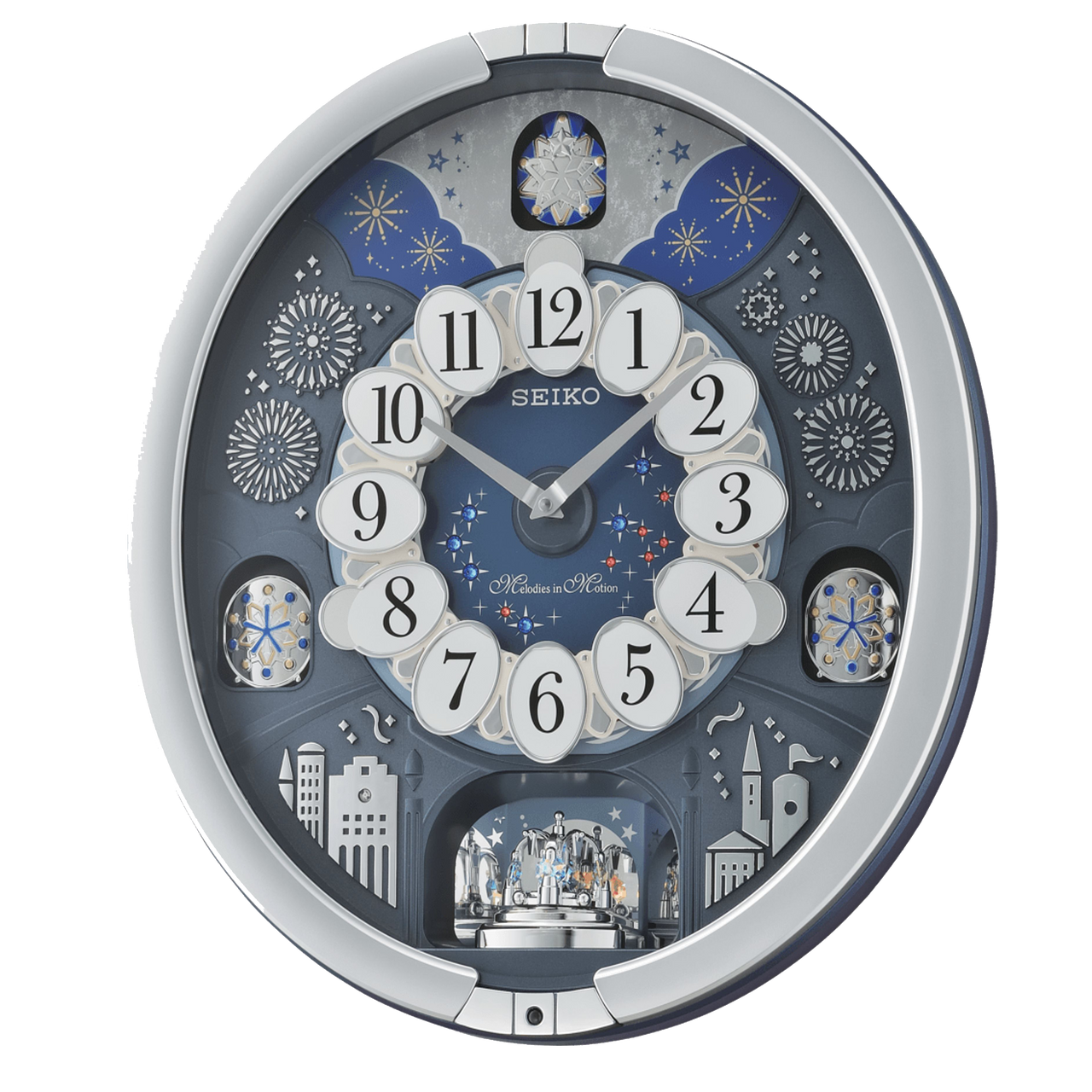 The Seiko Starry Night Melodies in Motion Clock (QXM379SRH) features an ornate cityscape with fireworks, stars, white oval number panels, and a decorative rotating scene adorned with sparkling Swarovski crystals.