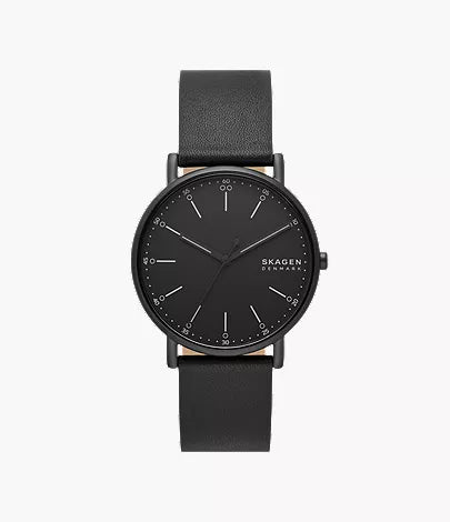 The Skagen Watch - Signatur - SKW6902 by Fossil features a minimalist 40mm case, black leather strap, black face with silver hour markers, and the brand name on the right side of the dial.