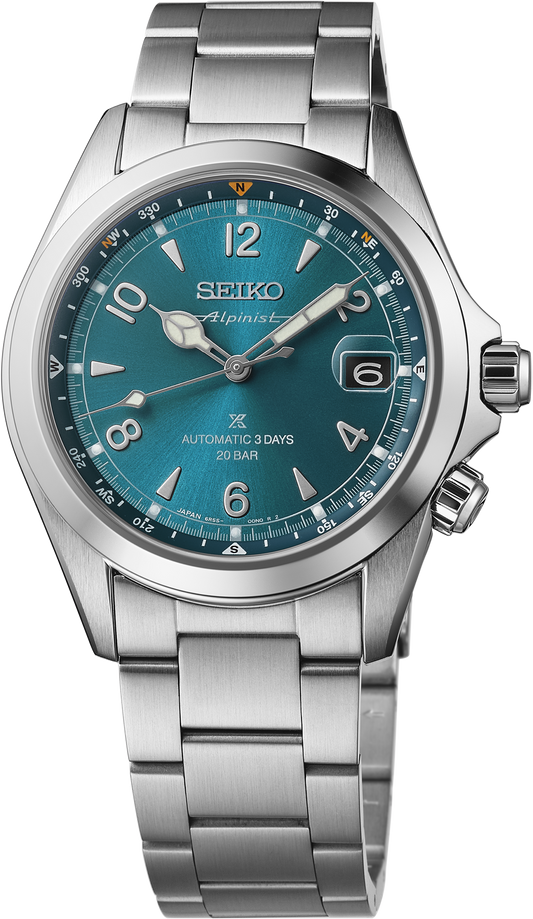 The Seiko Watch - Luxe Prospex Alpinist SPB503 features a teal dial, silver hour markers, a date window at 3 o’clock, metal bracelet, automatic movement with "Automatic 3 Days 20 Bar" on the dial. Brand: Seiko.