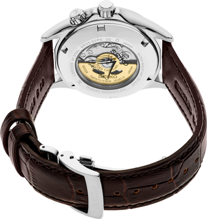 The Seiko Luxe Prospex Alpinist SPB507 showcases a green dial, brown leather strap with detailed stitching, silver clasp, and a transparent case back revealing the automatic movement.