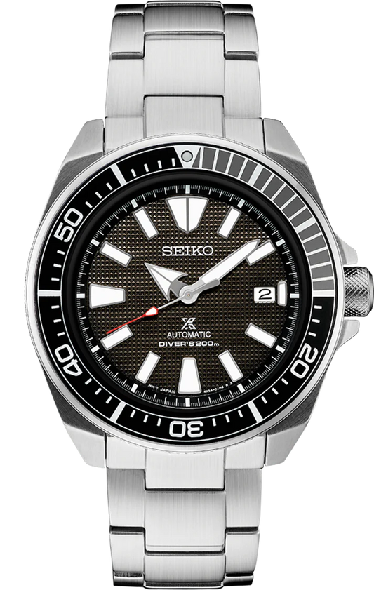 The Seiko Prospex Automatic Diver SRPF03 is a rugged 200m water-resistant stainless steel watch featuring a black textured dial, bold white markers, date at 3 o’clock, unidirectional bezel, and silver bracelet.