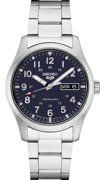 The Seiko Watch - Seiko 5 Sports Collection - SRPG29 features a stainless steel case and band, a dark blue dial with white Arabic numerals, and day-date display at 3 o’clock. This automatic watch includes three central hands.