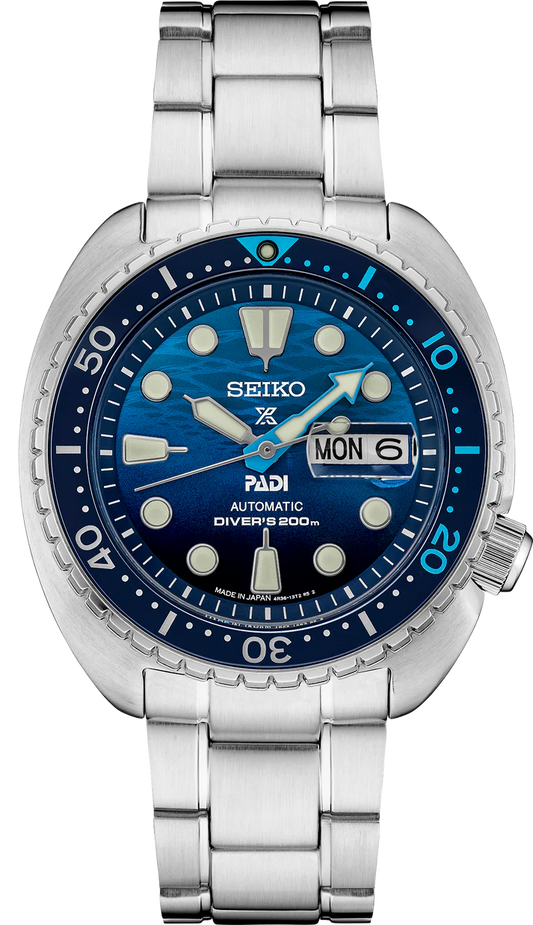 The Seiko Watch - Prospex PADI Special Edition - SRPK01 features a blue wave-pattern dial, silver indices, day-date window at 3 o’clock, stainless steel bracelet, and is water resistant up to 200m.